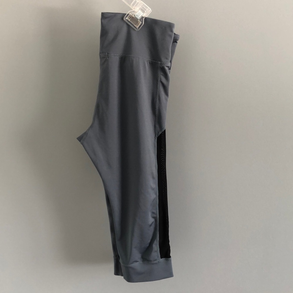 Athletic leggings with black mesh sides.